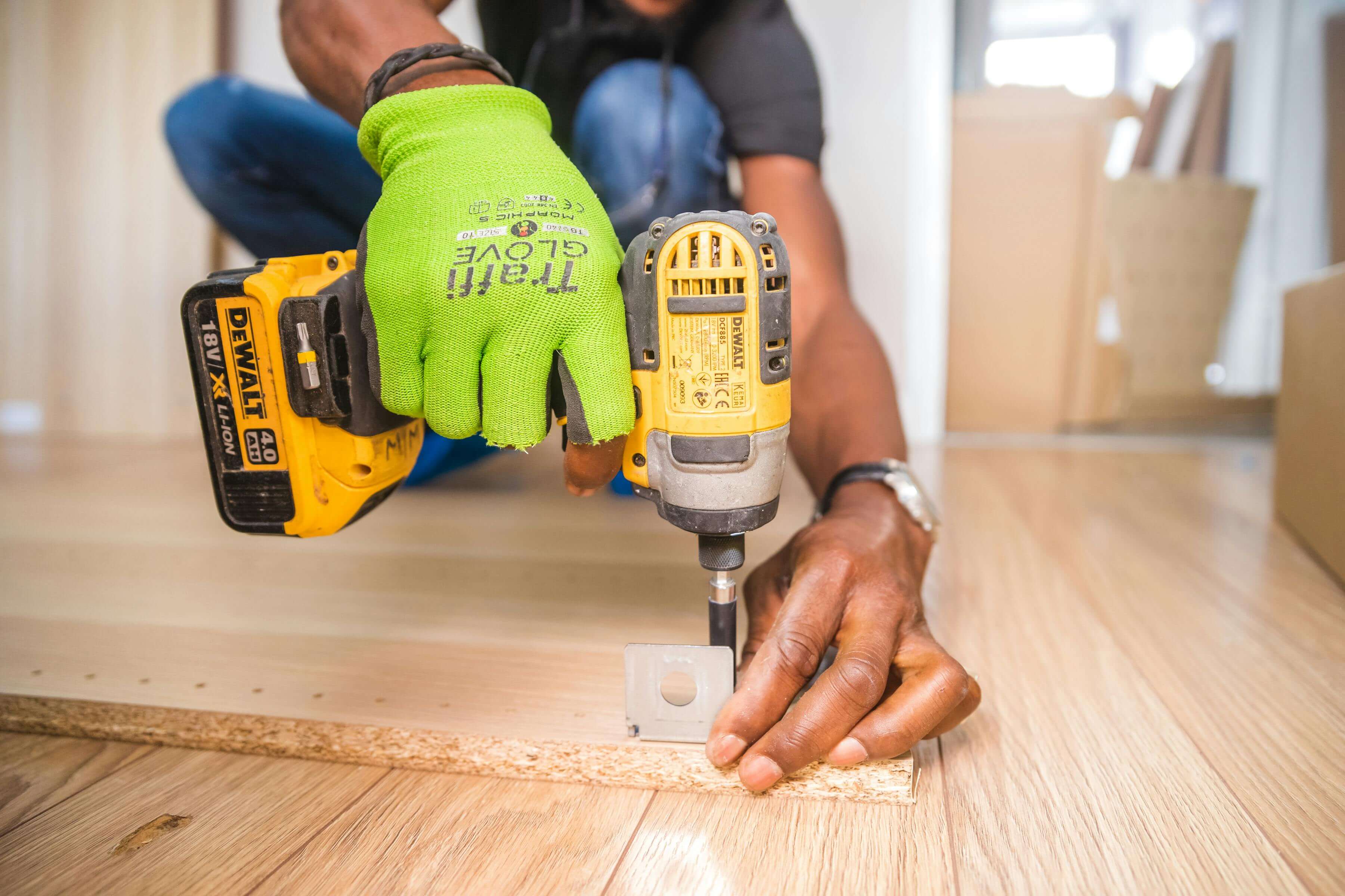 A close-up of a worker with a drill