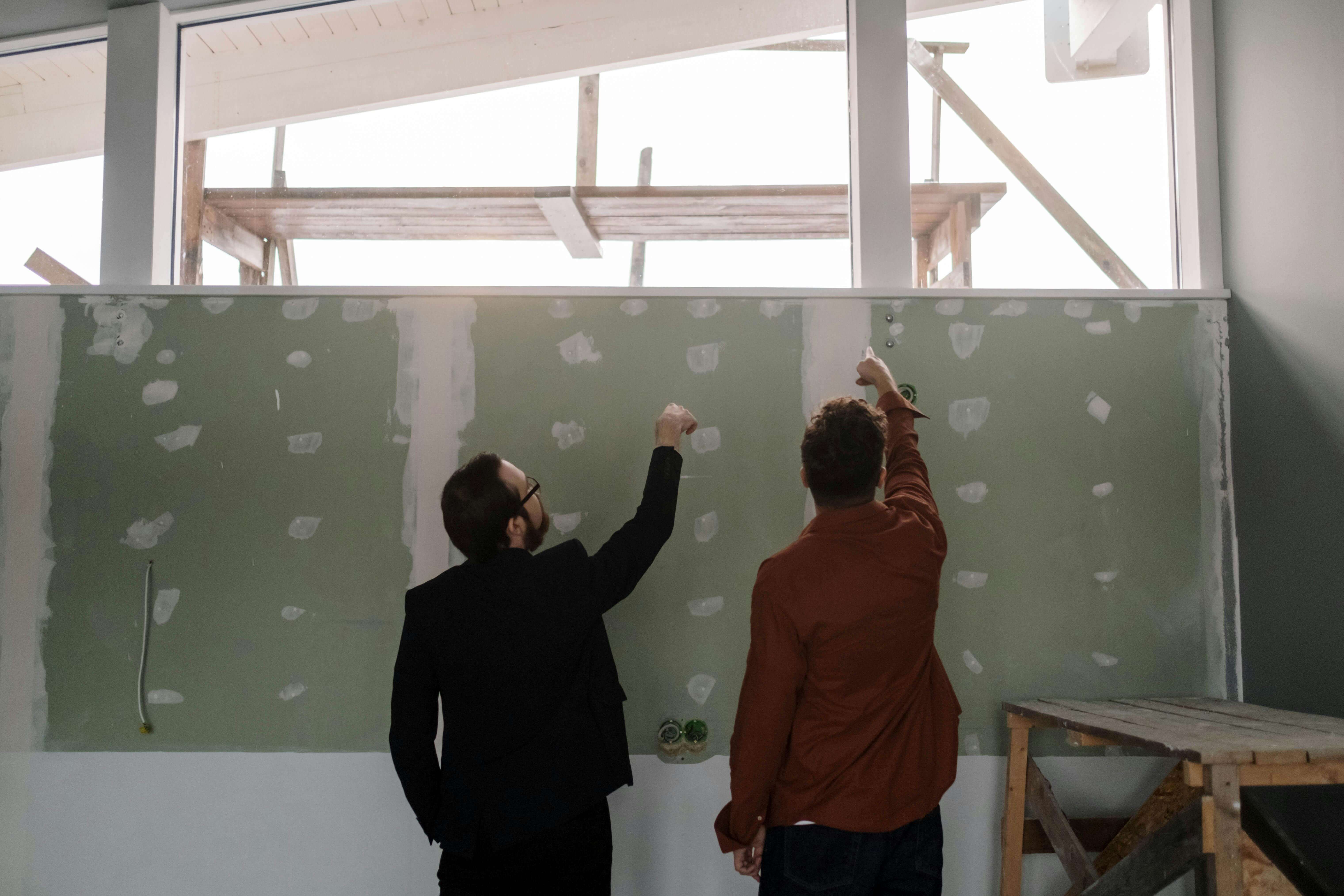 Our Process - Workers inspecting the condition of a wall
