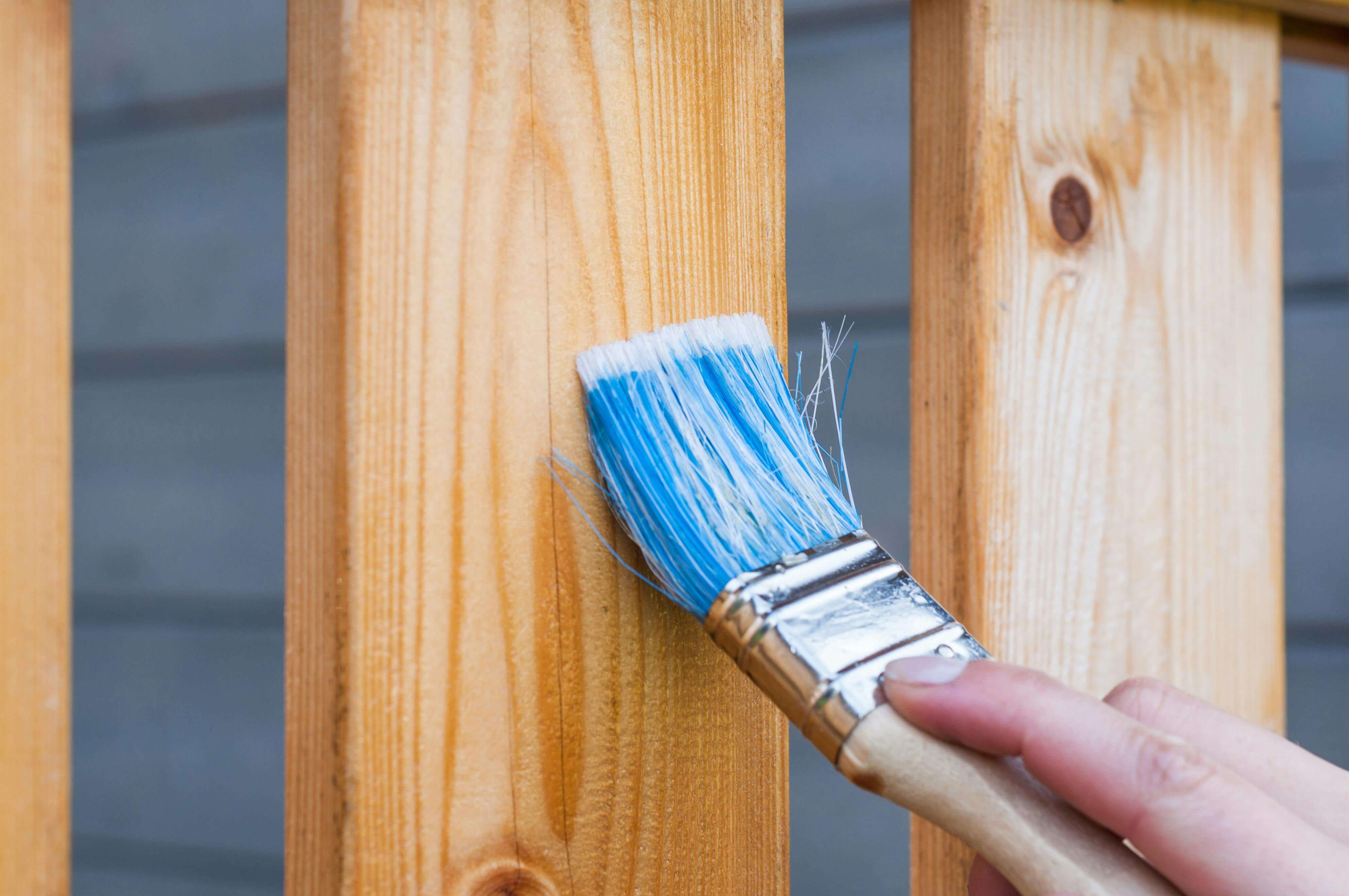 A paintbrush on a plank of wood